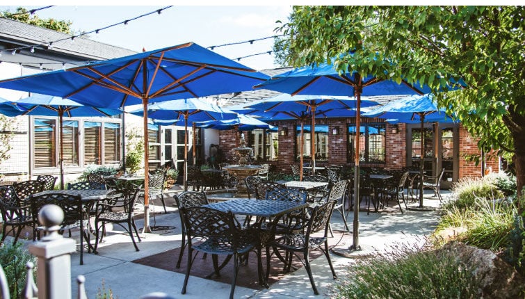 restaurant with commercial dining patio furniture and umbrellas